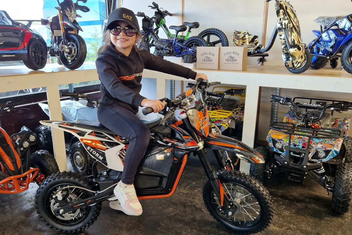 Zwart-oranje elektrische dirtbike met rijder